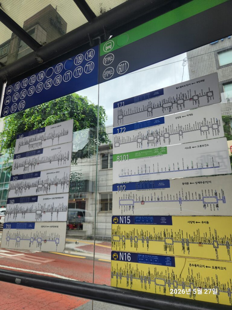 A close-up of a transit route map at a shelter for travelers looking to take the bus in Seoul, showcasing the Korean and English destination names.